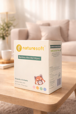 Box of Naturesoft Bamboo Mini Wet Wipes on a wooden table with a blurred background